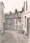 a pencil drawing looking down the hill in King Street, Robin Hoods Bay, showing houses and a pub